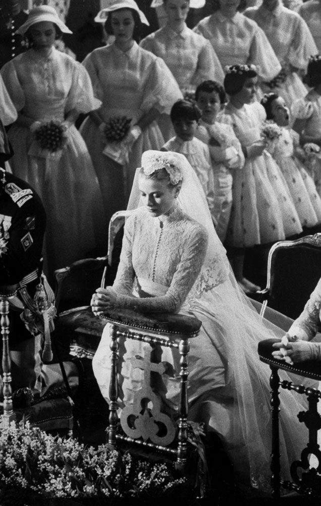 Grace Kelly prays before her wedding to Prince Rainier III, April 1956. (England's Queen Elizabeth II reportedly refused to attend the wedding because there were "too many movie stars.")