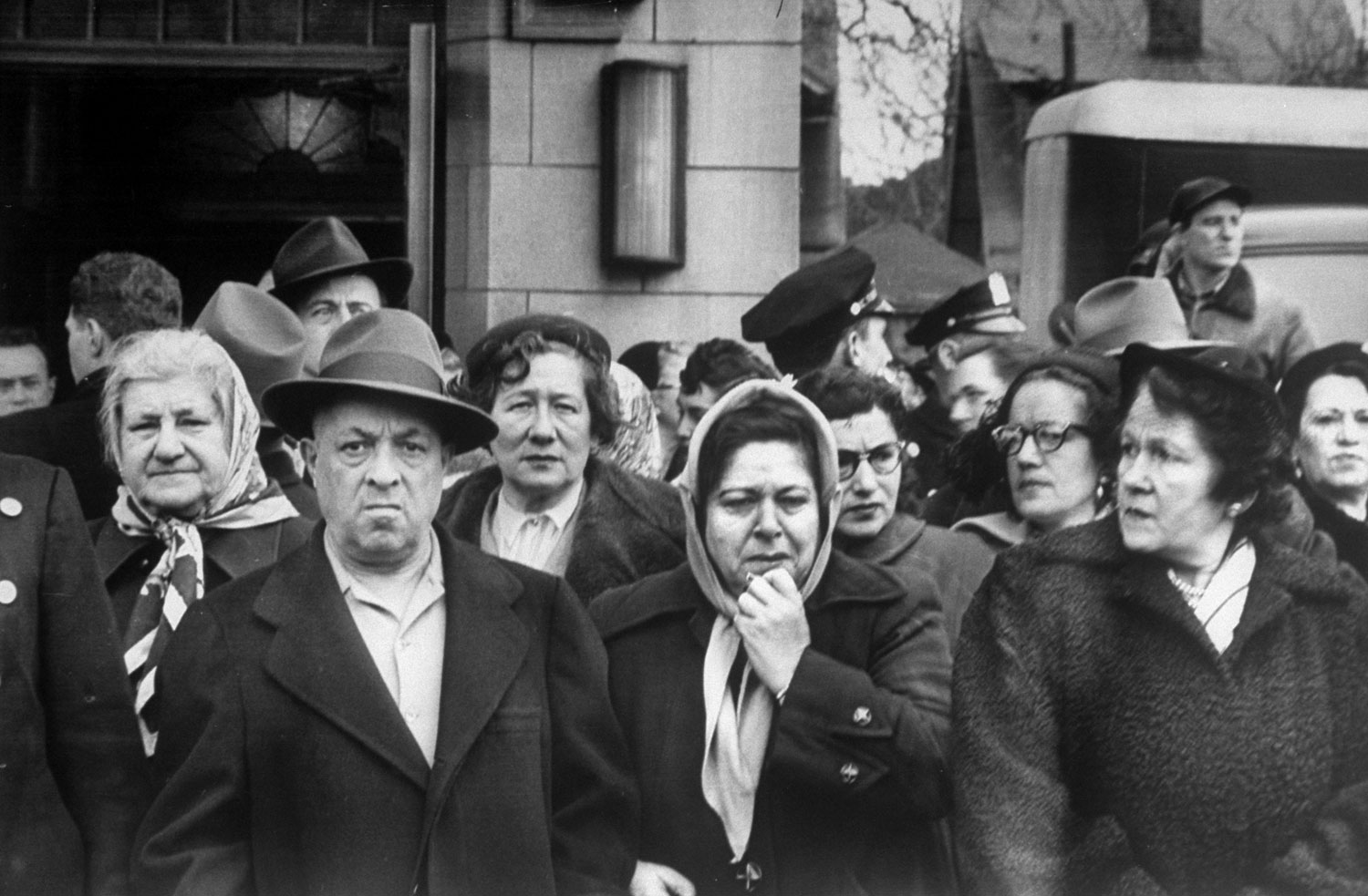 Shocked neighbors line the street waiting for Arnold Schuster's casket to be carried from funeral home, New York, 1952. Schuster, an amateur detective, was instrumental in the capture of bank robber Willie Sutton, and was murdered by members of the Gambino crime family.