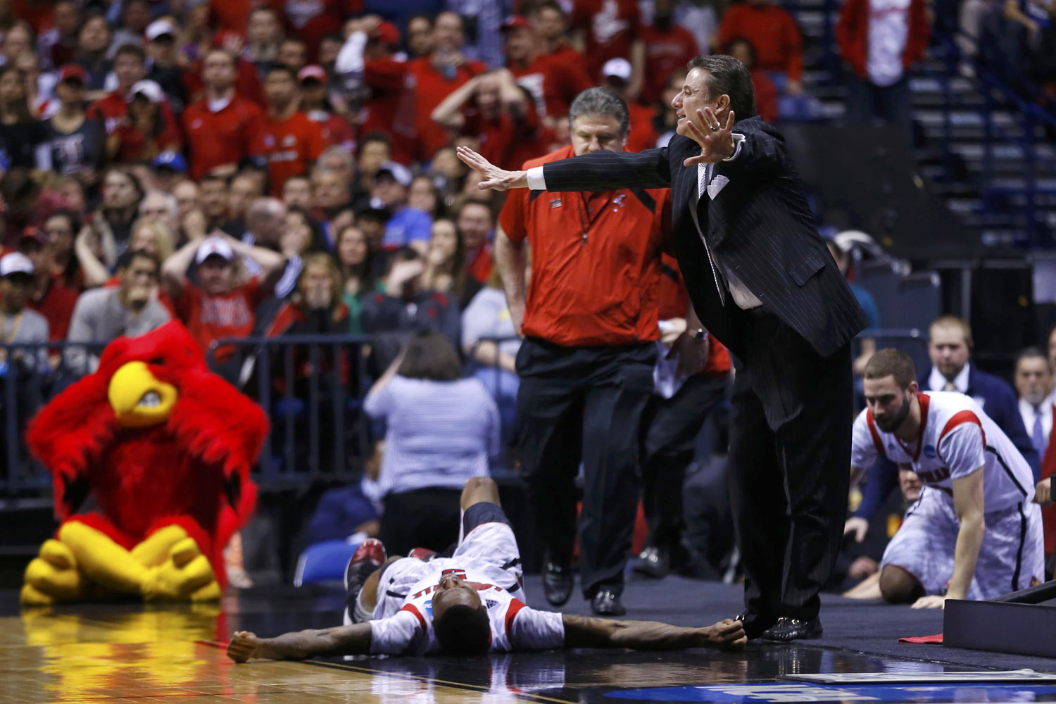 Louisville coach Pitino calls to the referees to stop the game as guard Kevin Ware lays on the court against Duke during their Midwest Regional NCAA men's basketball game in Indianapolis