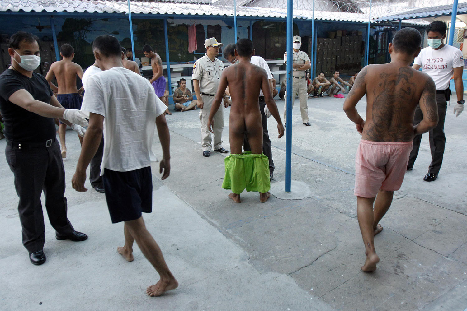 Prisoners are searched during an operation at the Nonthaburi prison near Bangkok