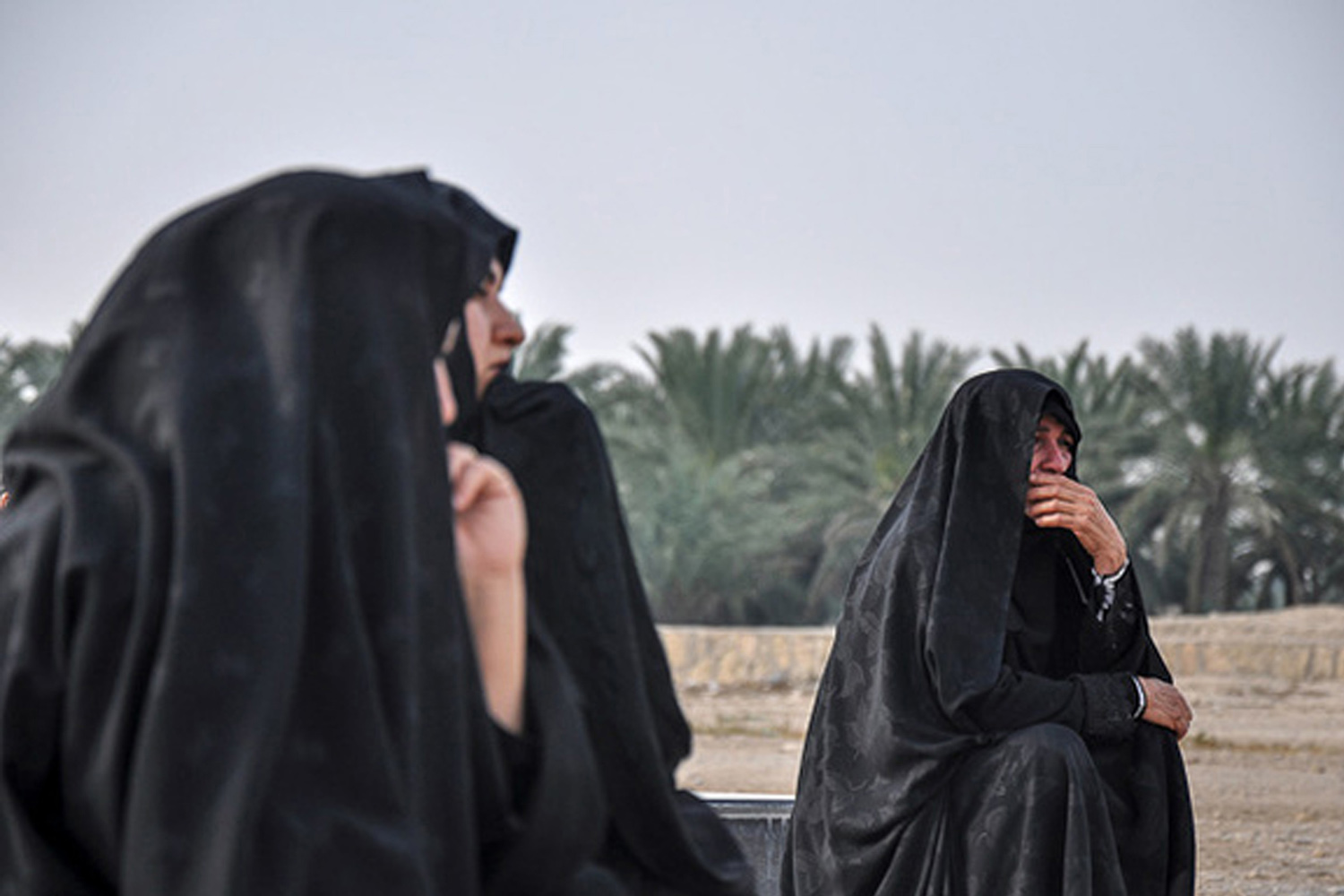 Women react as they attend the funeral of earthquake victims in the earthquake-stricken town of Khormoj in Bushehr province