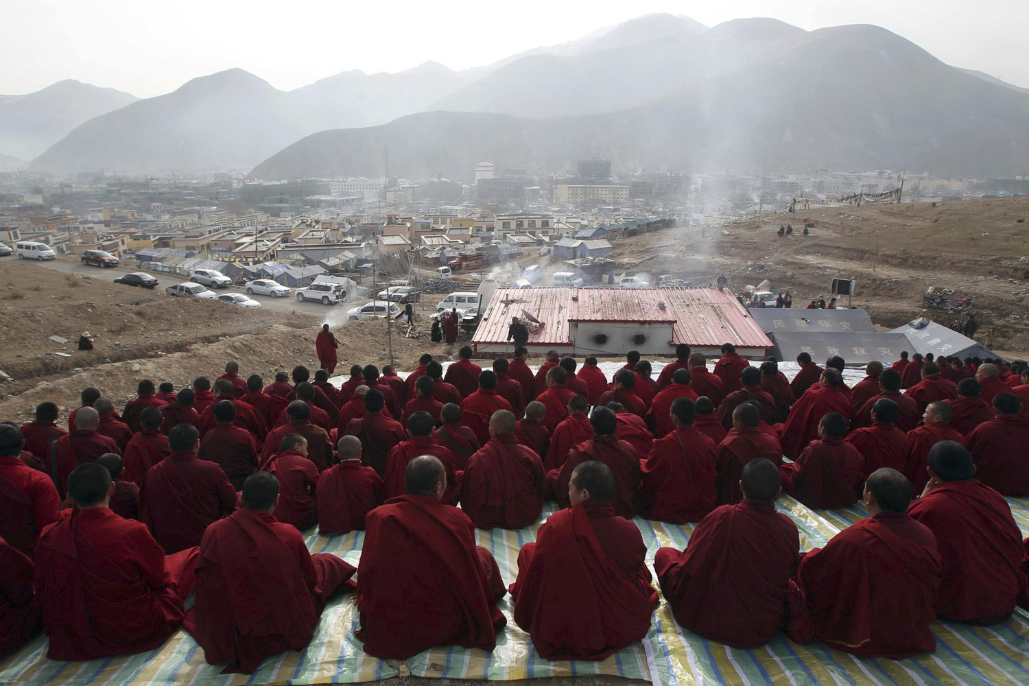 Tibetan Buddhist monks attend a mass prayer in memorial for victims of the earthquake which hit Yushu county three years ago, in Yushu