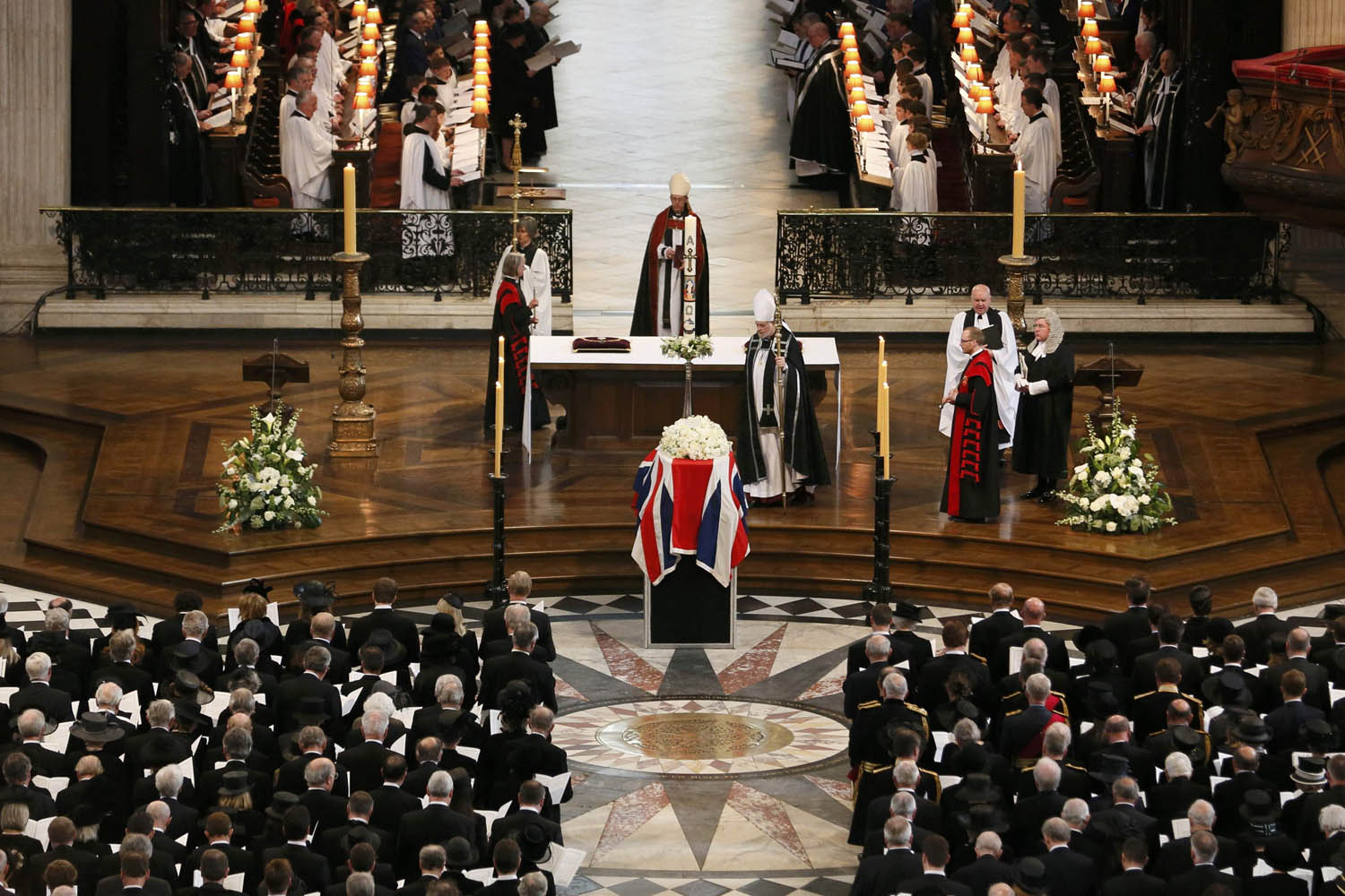 April 17, 2013. The Archbishop of London, Richard Chartres (C), walks behind the coffin of former British prime minister Margaret Thatcher during her funeral service at St Paul's Cathedral in London.