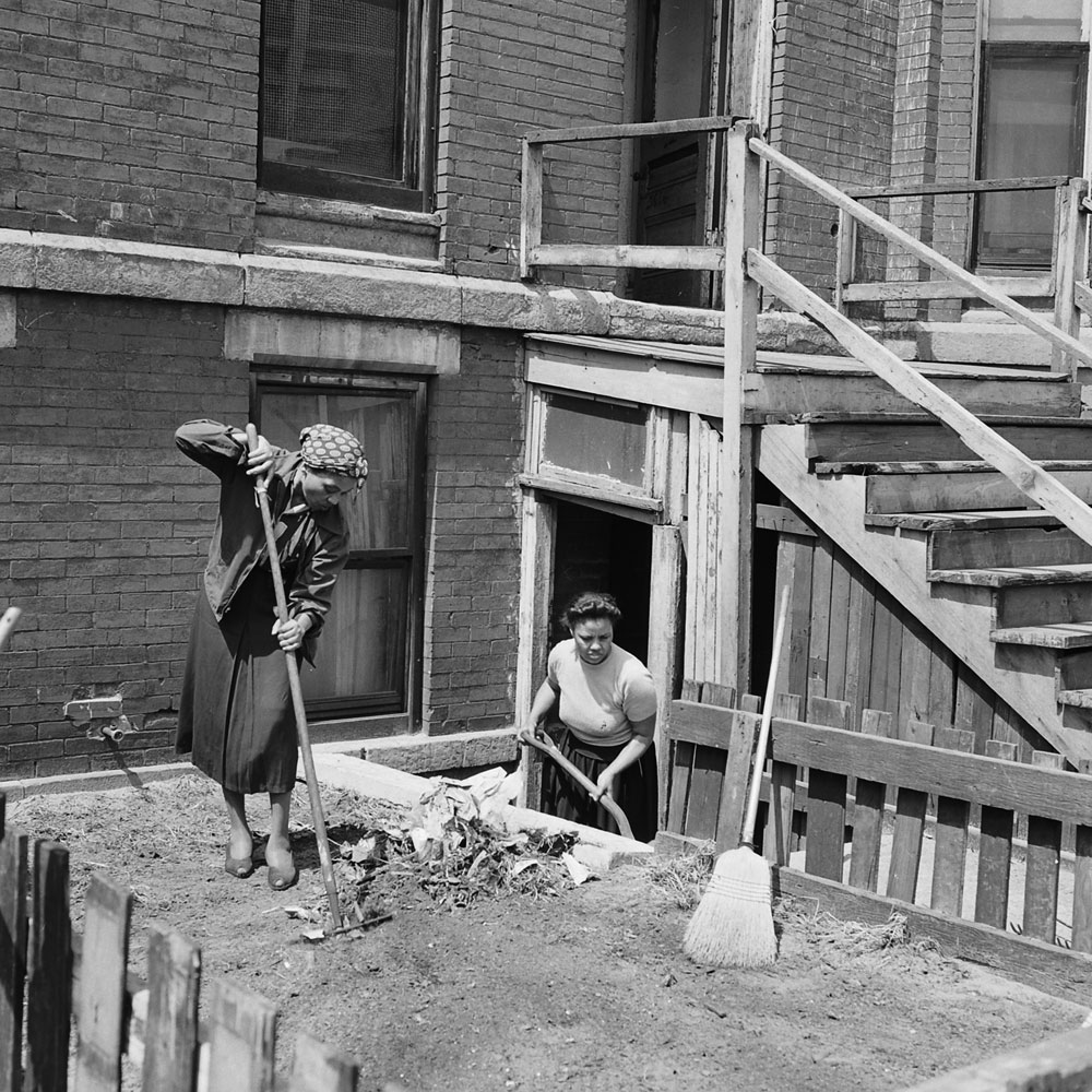 Women cleaning in front of a tenement house, Chicago, 1954.