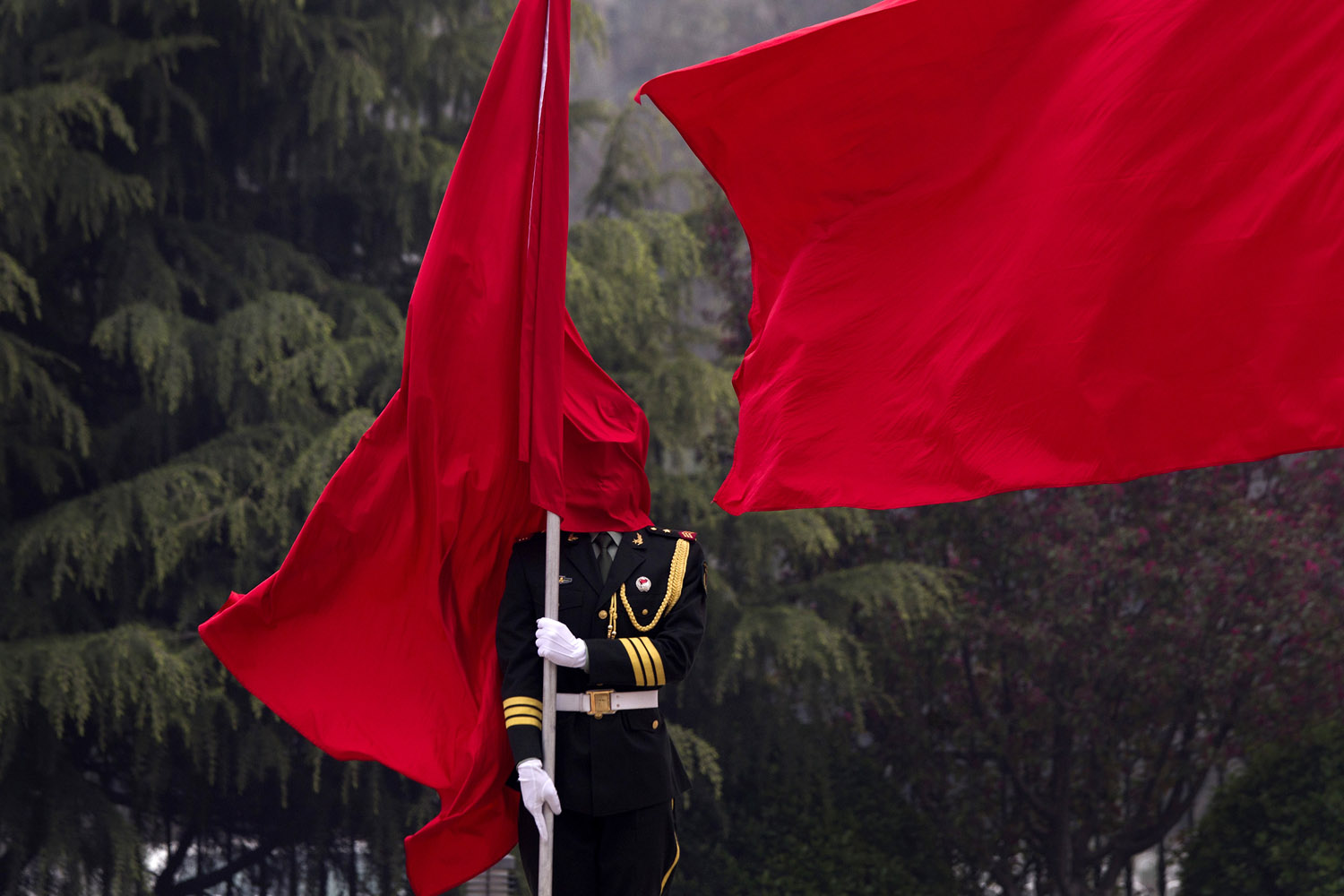 April 22, 2013. A honor guard is covered by a flag during a welcoming ceremony for U.S. Joint Chiefs Chairman Gen. Martin Dempsey at the Bayi Building in Beijing.