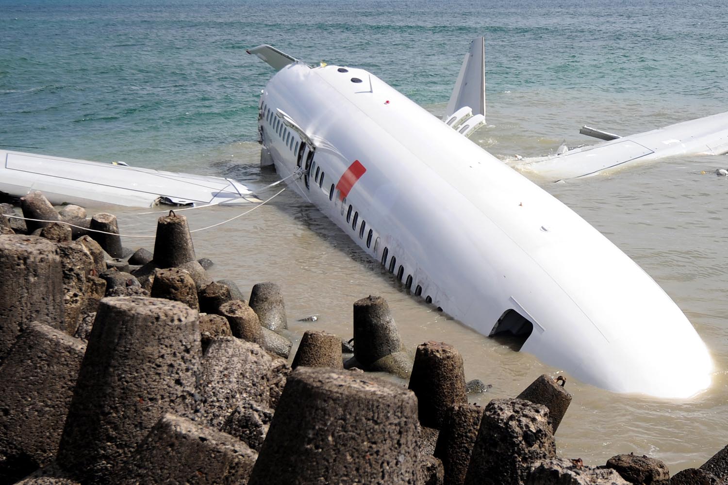 April 16, 2013. A Lion Air Boeing 737 lies partially submerged in the water two days after it crashed on landing at Bali's international airport near Denpasar.