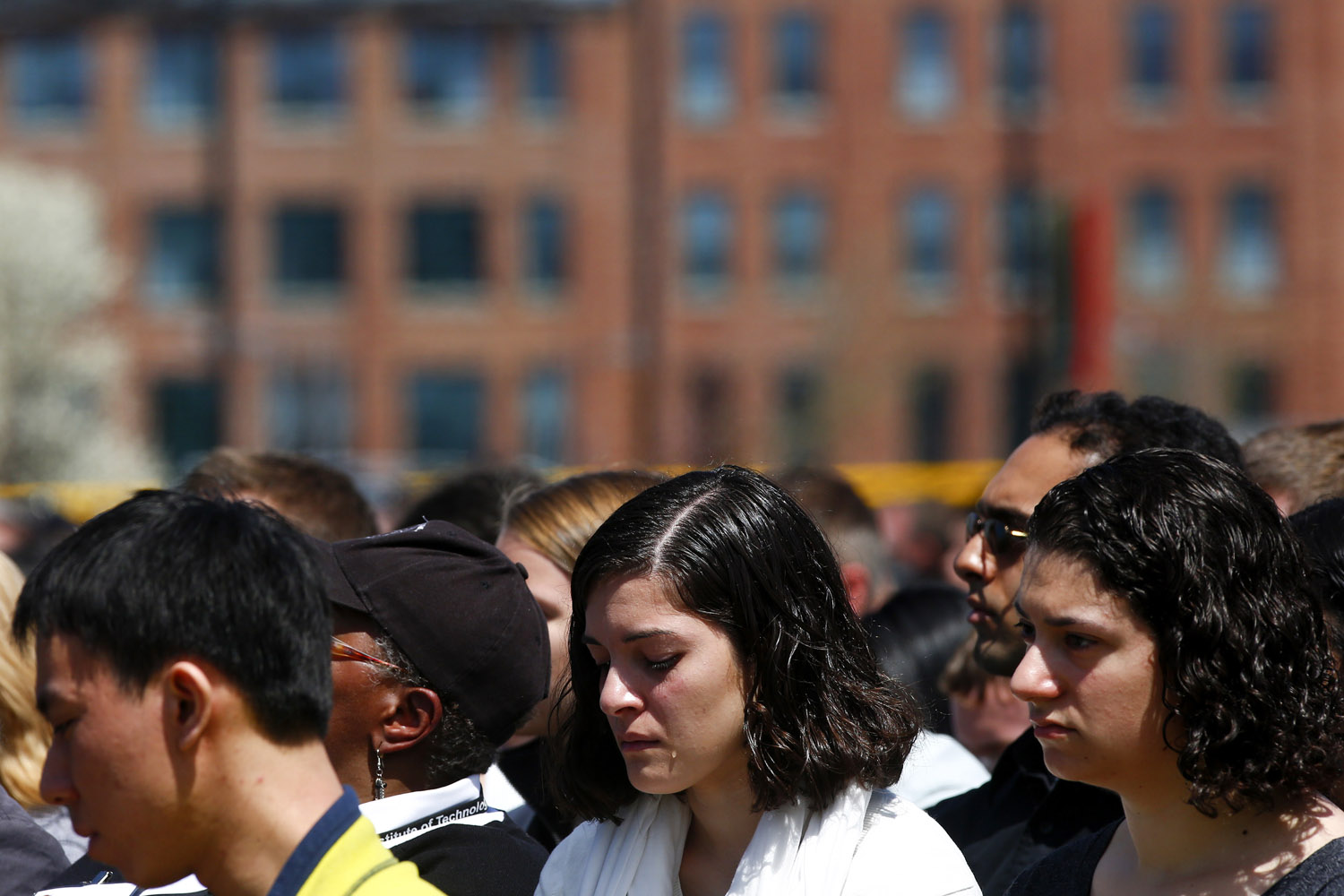 April 23, 2013. A woman cries during a memorial service for Massachusetts Institute of Technology police officer Sean Collier, at Briggs Field on the university's campus in Cambridge.