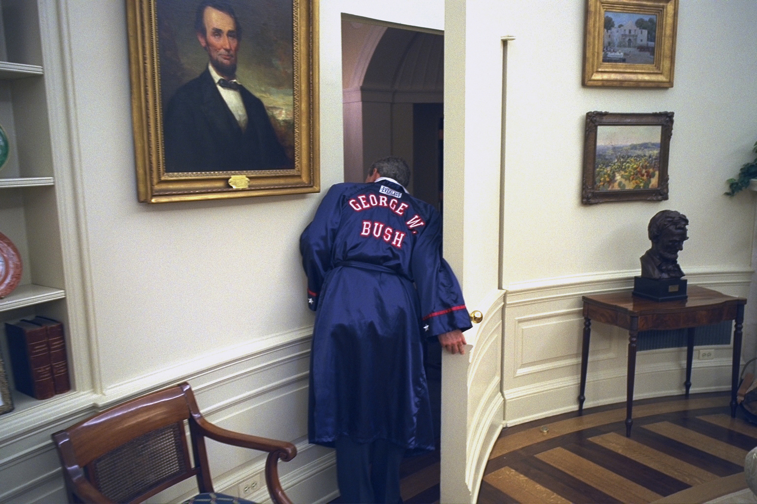 Oct. 8, 2002. In a light moment, President Bush, wearing a  George W. Bush  boxing robe, peeks around the Oval Office doorway into the hallway.“President Bush was mostly a serious leader, tackling serious issues. But this sense of humor provided a break for many of us in the White House.”