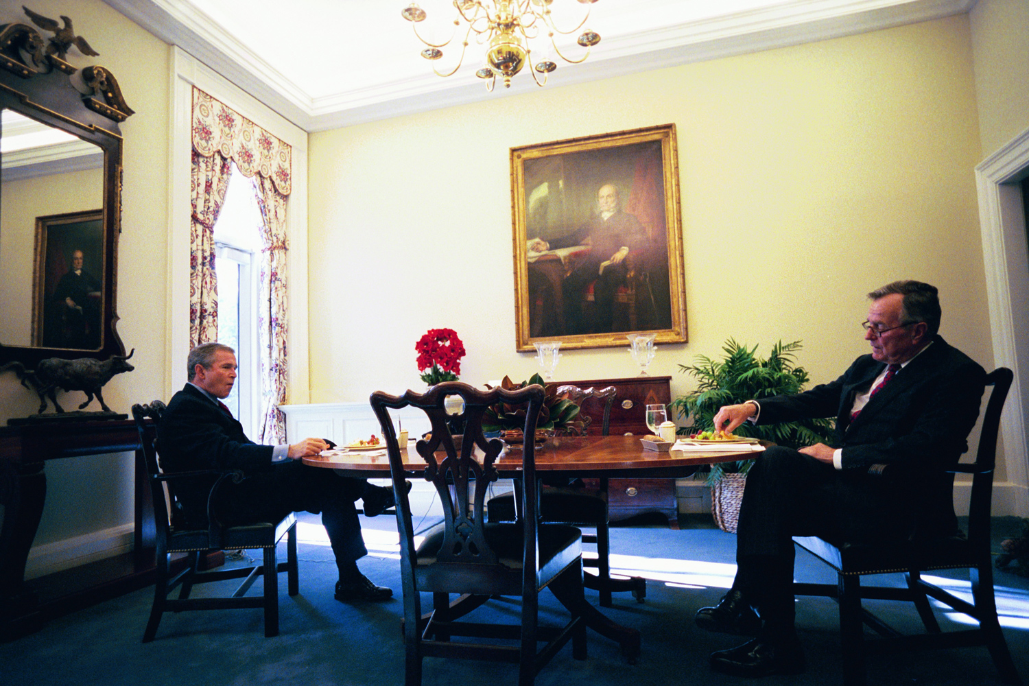 Dec. 12, 2003. President Bush and his father lunch in the private Oval Office dining room under the portraits of President John Quincy Adams, the only other president who was the son of a former U.S. President.“They had such a normal relationship, much more father and son than two presidents.”