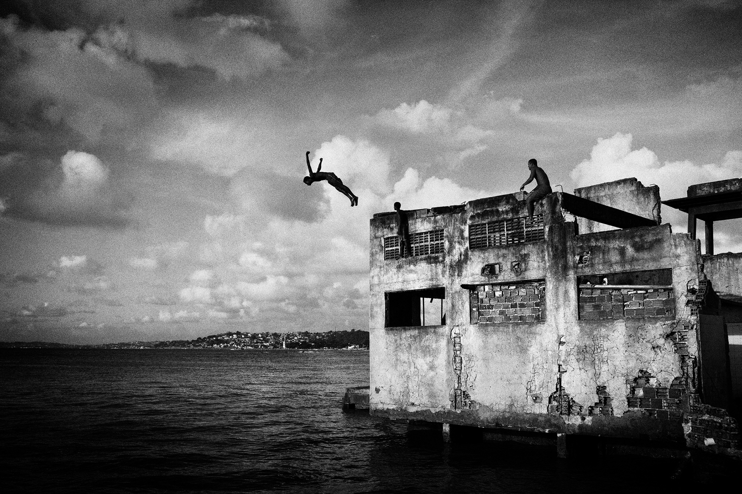 SALVADOR DE BAHIA, BRAZIL – MARCH 20, 2011: A boy jumping from a building of the abandonated chocolate factory, on March 20, 2011 in Salvador de Bahia, Brazil. Despite the lack of socio-economic support from the government, they have managed to make a safe place for themselves to live, and form a community of their own, which is safer that the alternatives available to them. However they are currently being evicted by the government due to being there illegally. (Photo by Sebastian Liste/Reportage by Getty Images)