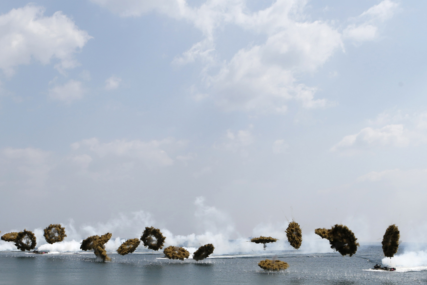 April 26, 2013. Amphibious assault vehicles of the South Korean Marine Corps throw smoke bombs as they move to land on shore during a U.S.-South Korea joint landing operation drill in Pohang, about 370 km (230 miles) southeast of Seoul.