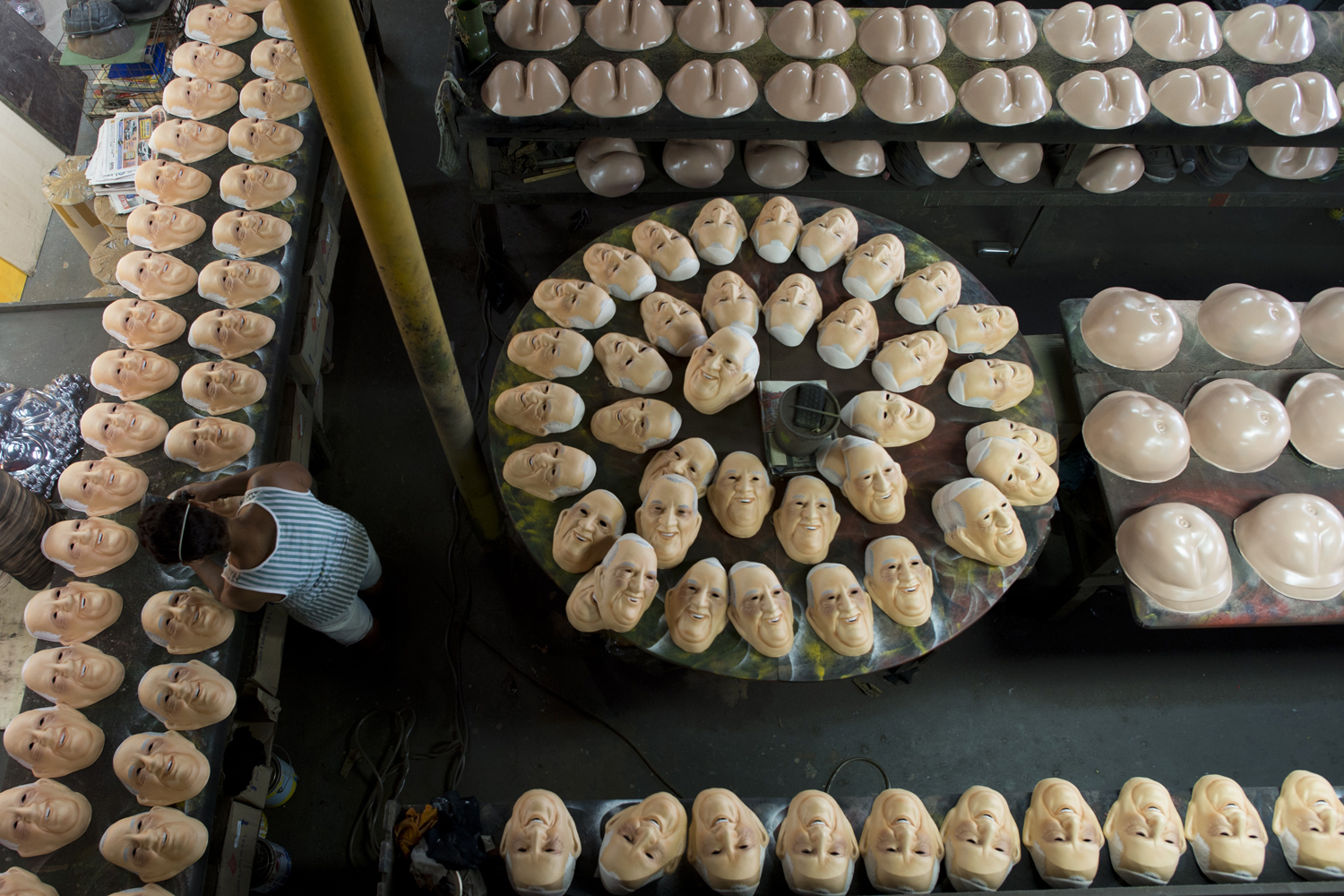 April 17, 2013. A woman paints masks representing Pope Francis in a factory in Niteroi, 20 Km from Rio de Janeiro, Brazil.