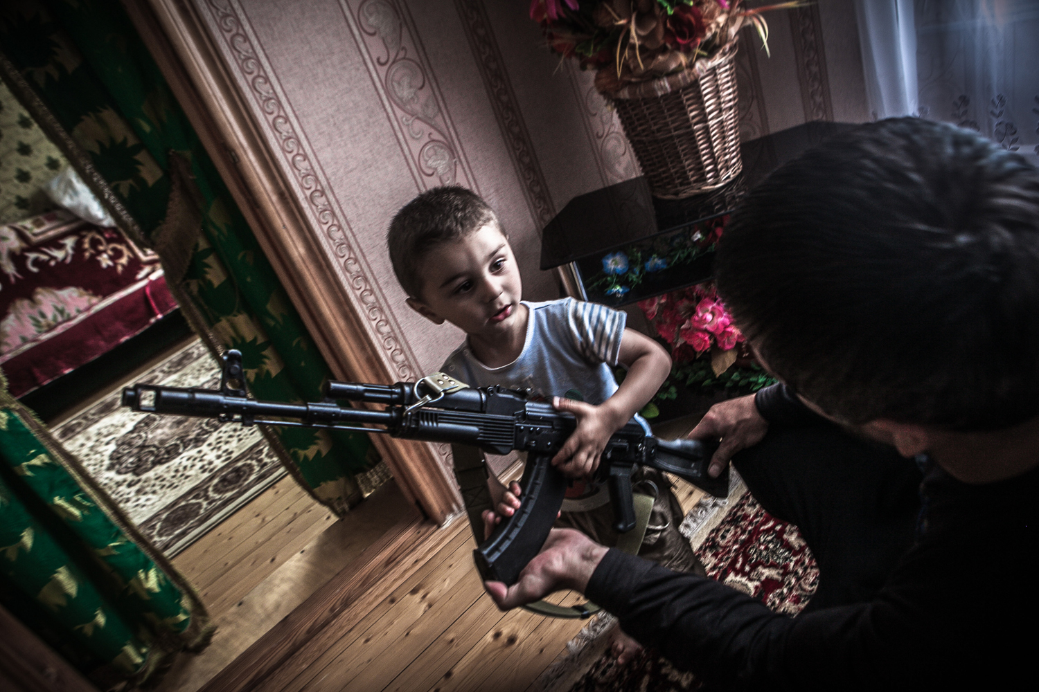 Magomed, a school teacher, shows to his 2year-old nephew how to hold a weapon.Dagestan is the biggest and the most multinational republic in the North Caucasus region. The society is mostly based on traditions and still is very conservative.