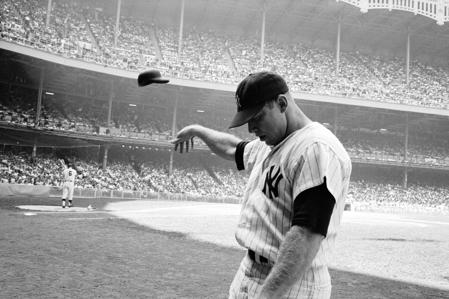 Mickey Mantle flings his batting helmet in disgust after a lousy at-bat, Yankee Stadium, 1965.