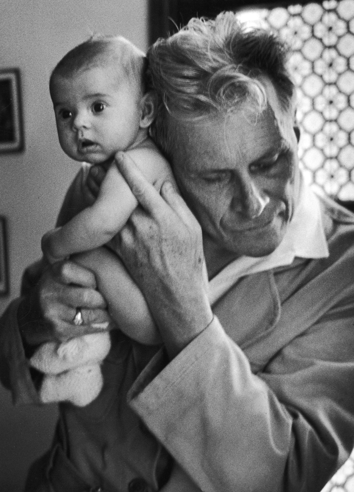 Blind doctor Albert-Andre Nast holds his ear to the back of a 3-month old instead of using a stethoscope, France, 1953.