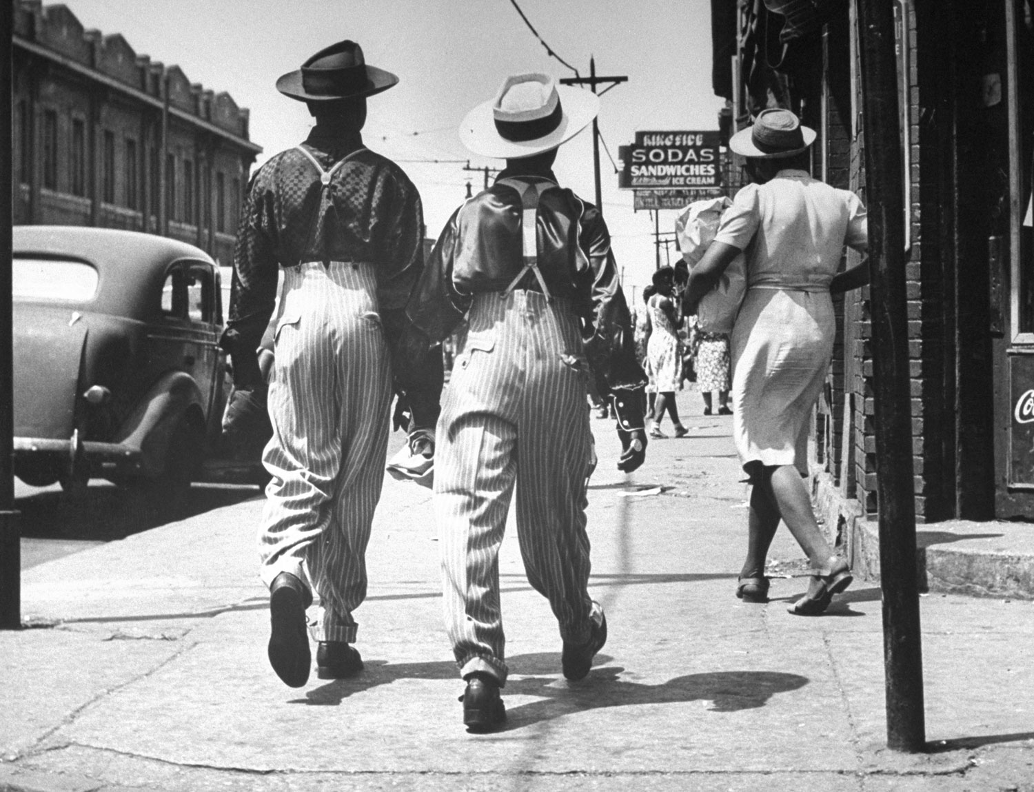 Not published in LIFE. A pair of zoot suit-wearing African American men walk down a Detroit street after wartime race riots between blacks and whites were quelled by Army troops and martial law, June 1943.