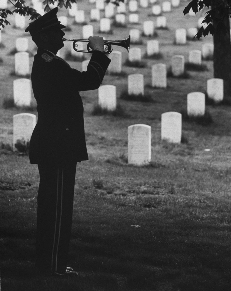 A bugler plays "Taps" at Arlington National Cemetery, 1965.