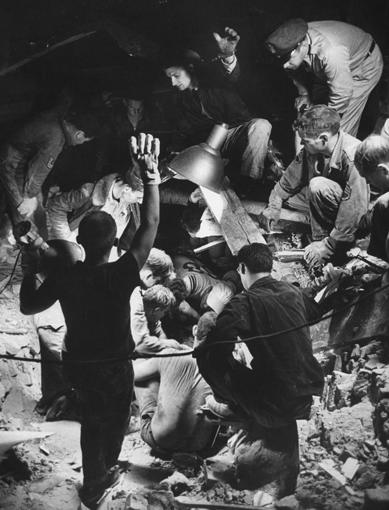 Rescuers attempt to free a woman trapped in rubble, Waco, Texas, May 1965.