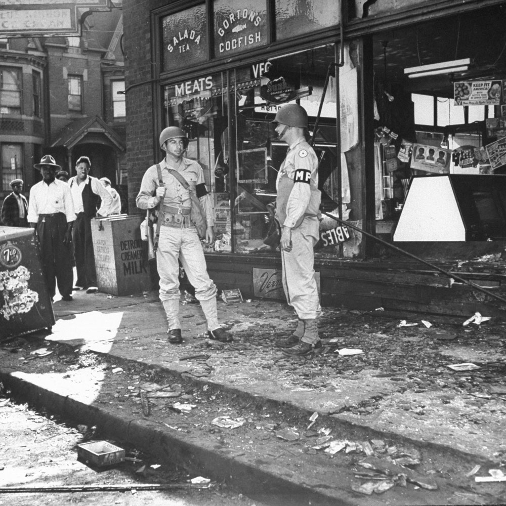 Not published in LIFE. Military police guard a Detroit store from looters after wartime race riots in the city, June 1943.
