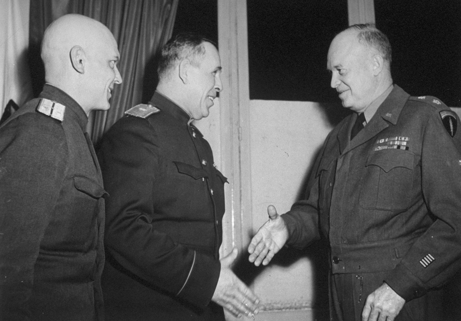 After surrender, Eisenhower (right) seizes hand of General Susloparov and says, 'This is a great moment for us all.' But surrender announcement was held up for Moscow approval.