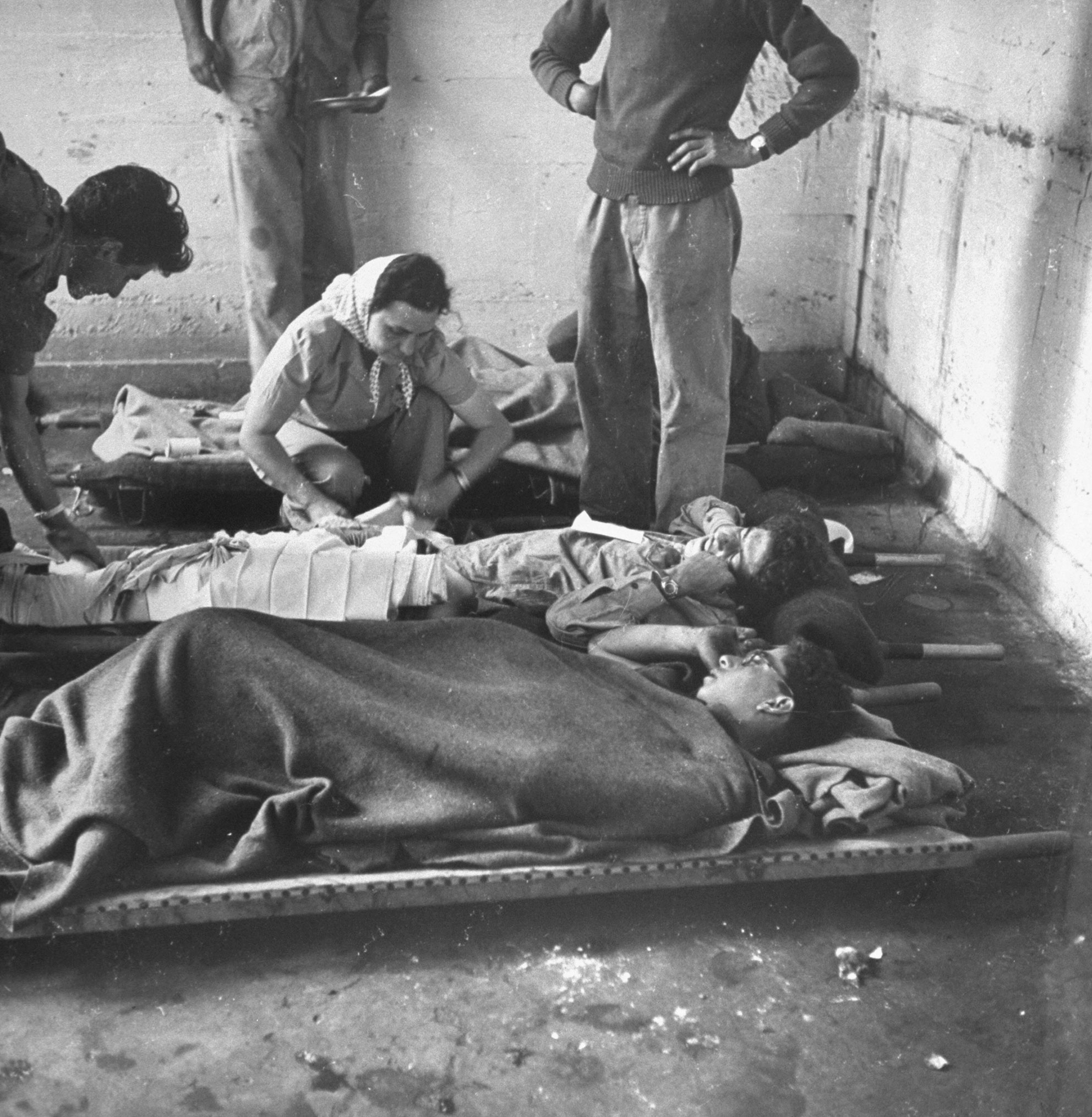 Israeli wounded being cared for in forward first aid station, shortly after the establishment of the state of Israel, exact location unknown, May 1948.