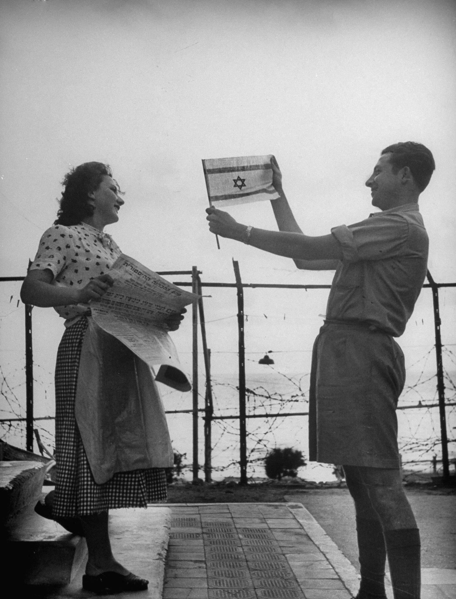 Happily displaying the Israeli flag shortly after the establishment of the state of Israel, exact location unknown, May 1948.
