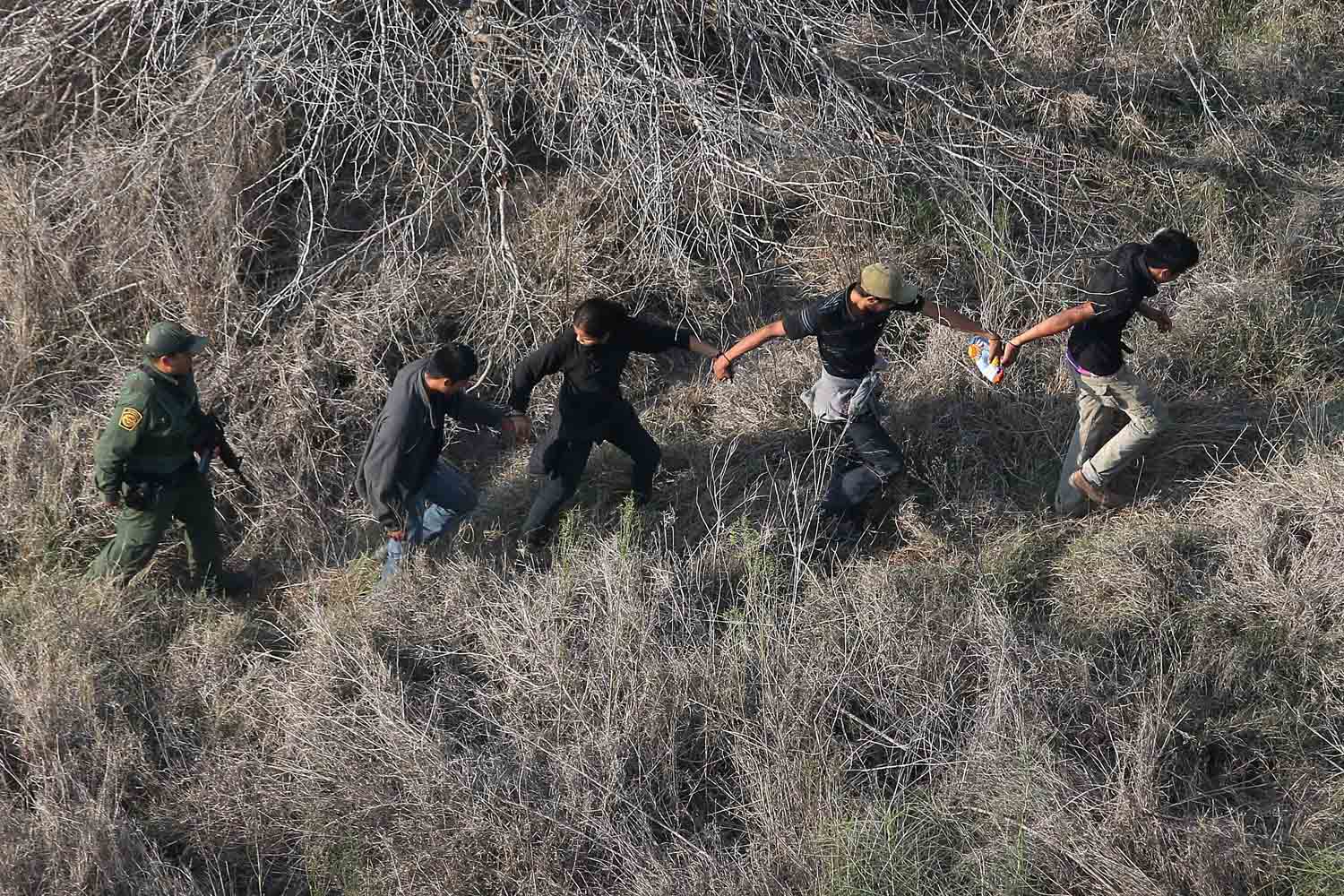 Customs And Border Protection Agents Detain Immigrants On Mexican Border