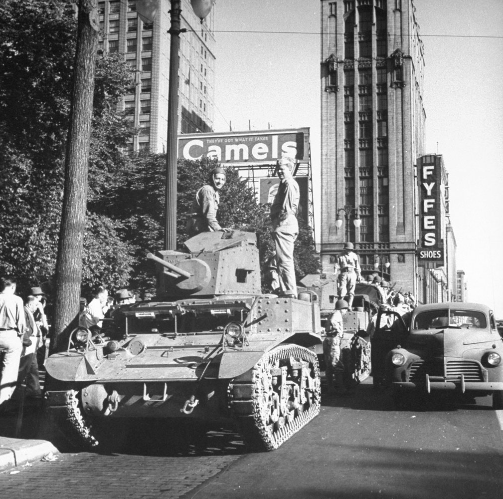 An M3 Stuart tank parked on a Detroit street to maintain order after wartime race riots swept the city in June 1943.