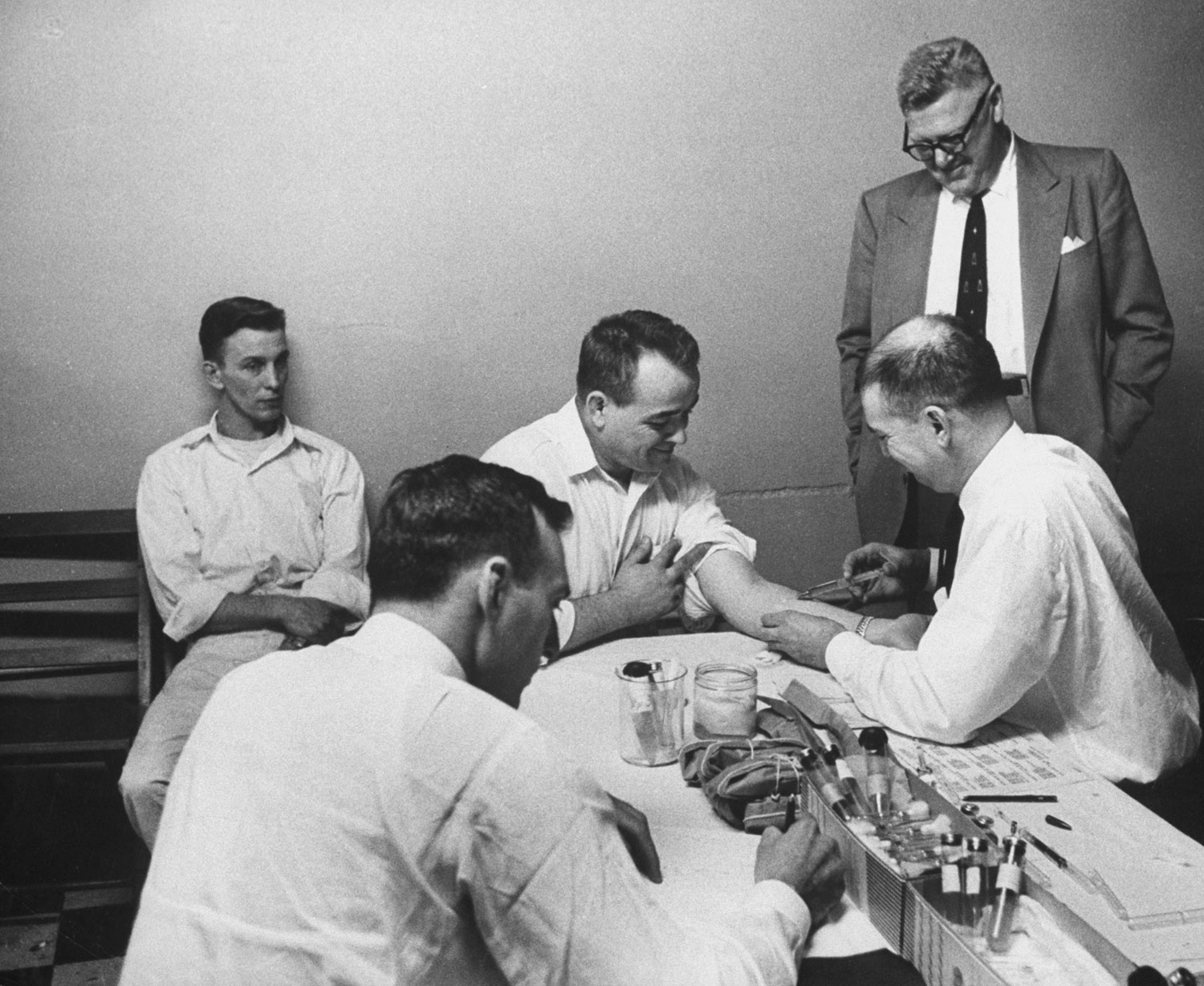 Doctors at Ohio State Penitentiary inject living cancerous cells into a prisoner's arm to test natural immunity, 1958.