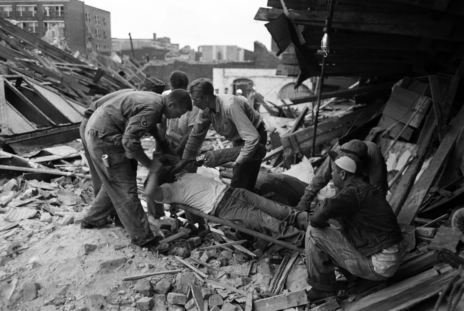 Rescuers administer oxygen to a survivor in Waco, Texas, after an F5 tornado hit the city, May 1953.