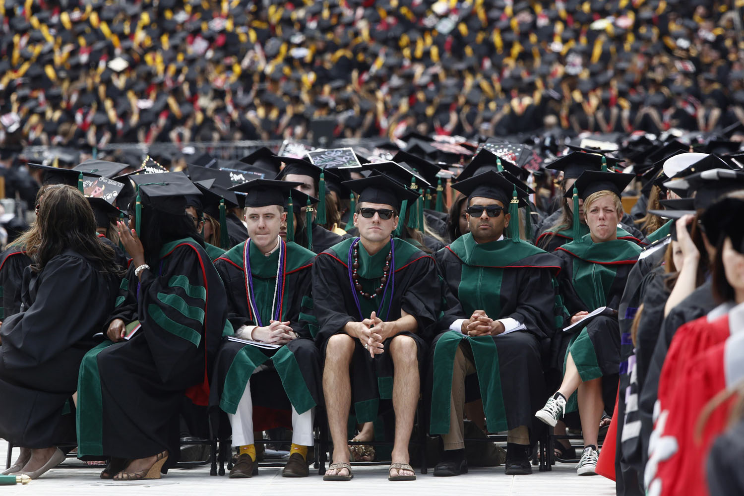 A student in flip flops and shorts attends commencement at Ohio State University