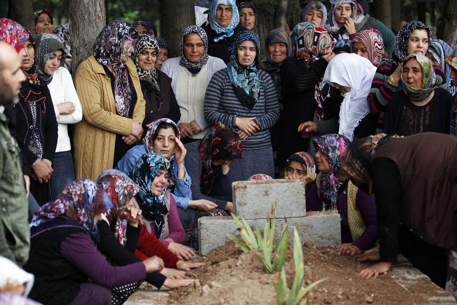 Relatives of Ahmet Uyan and Ahmet Ceyhan who were killed in yesterday's car bombings mourn in the town of Reyhanli of Hatay province near the Turkish-Syrian border