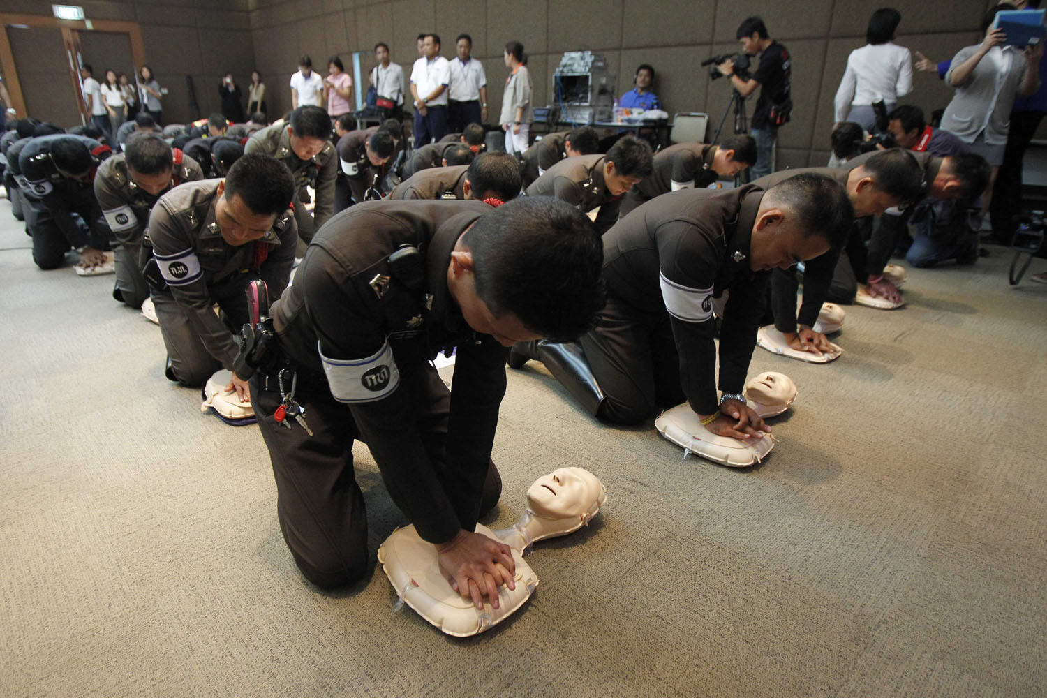 Thai traffic police officers practise cardiac resuscitation during an emergency situation and baby delivery training course at Bangkok hospital in Bangkok