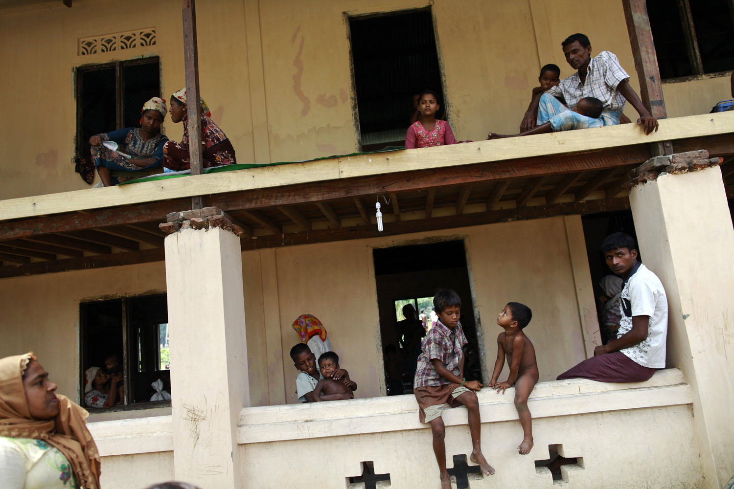 People pass time in a mosque, where they were evacuated to shelter from cyclone Mahasen when it landed, outside of Sittwe