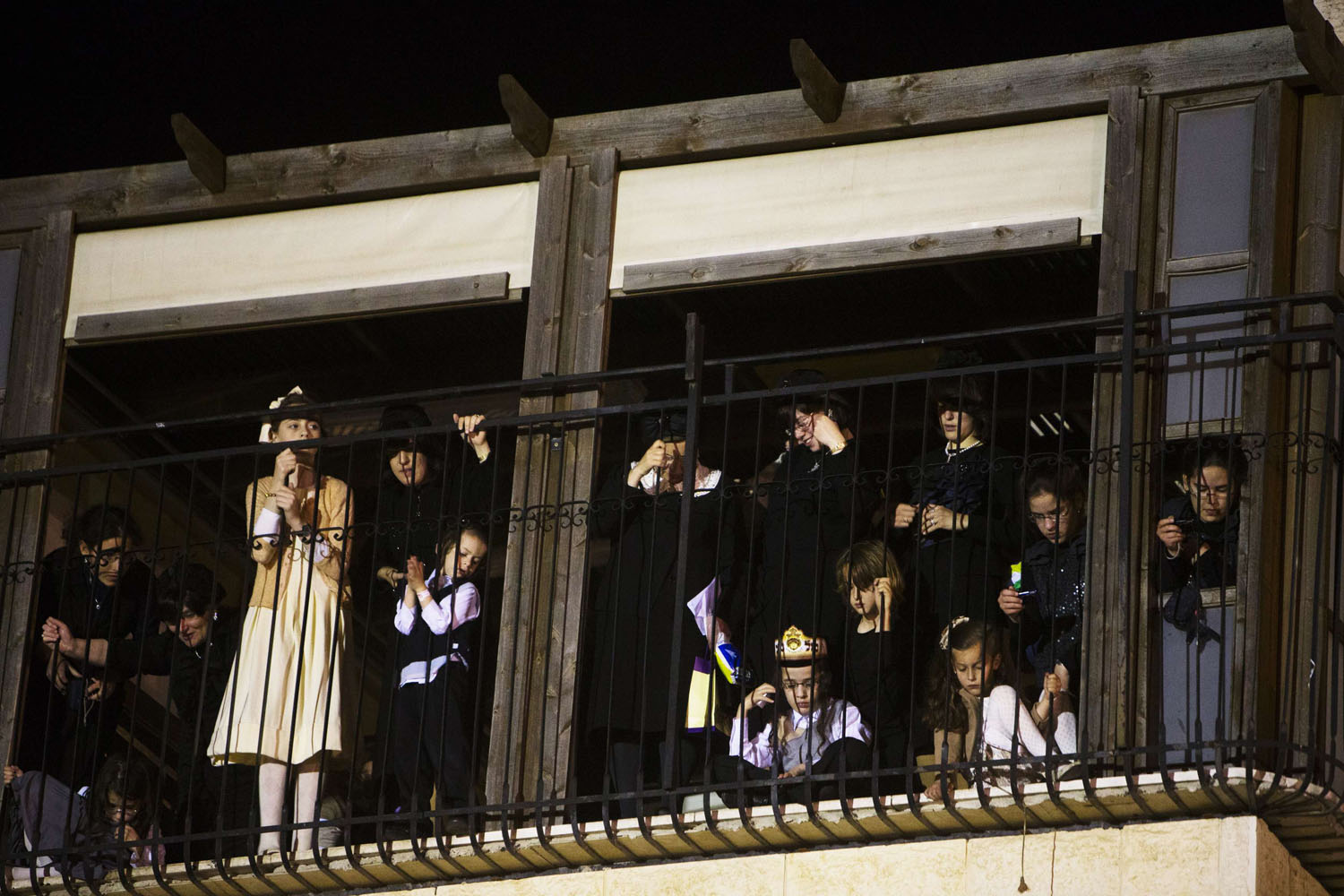 Ultra-Orthodox Jewish children stand on a balcony as they watch the wedding ceremony of Rokeach, the grandson of the Chief Rabbi of Belz, and his bride Penet, in Jerusalem