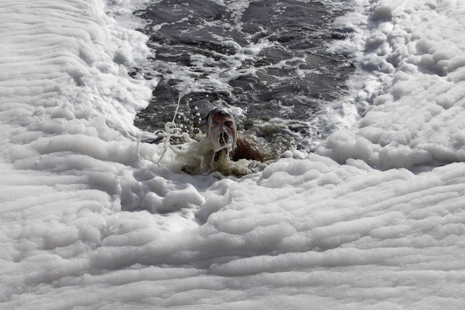 May 29, 2013. A man swims in the polluted waters of river Yamuna on a hot day in New Delhi.