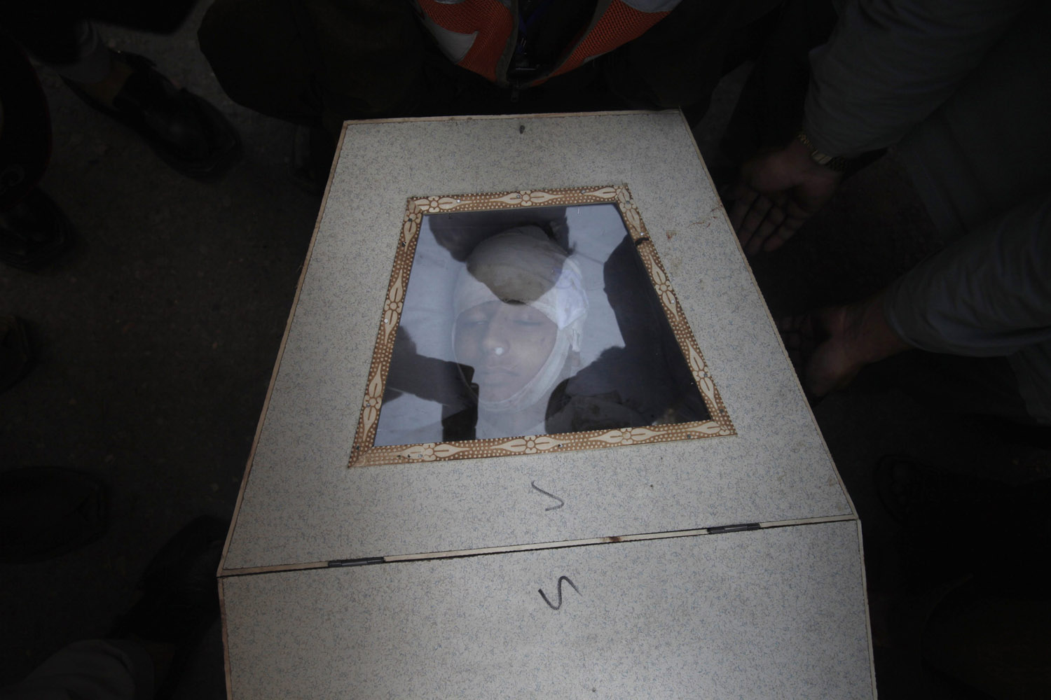 The coffin of a boy who was killed in a bomb blast waits to be transported from a hospital in Peshawar