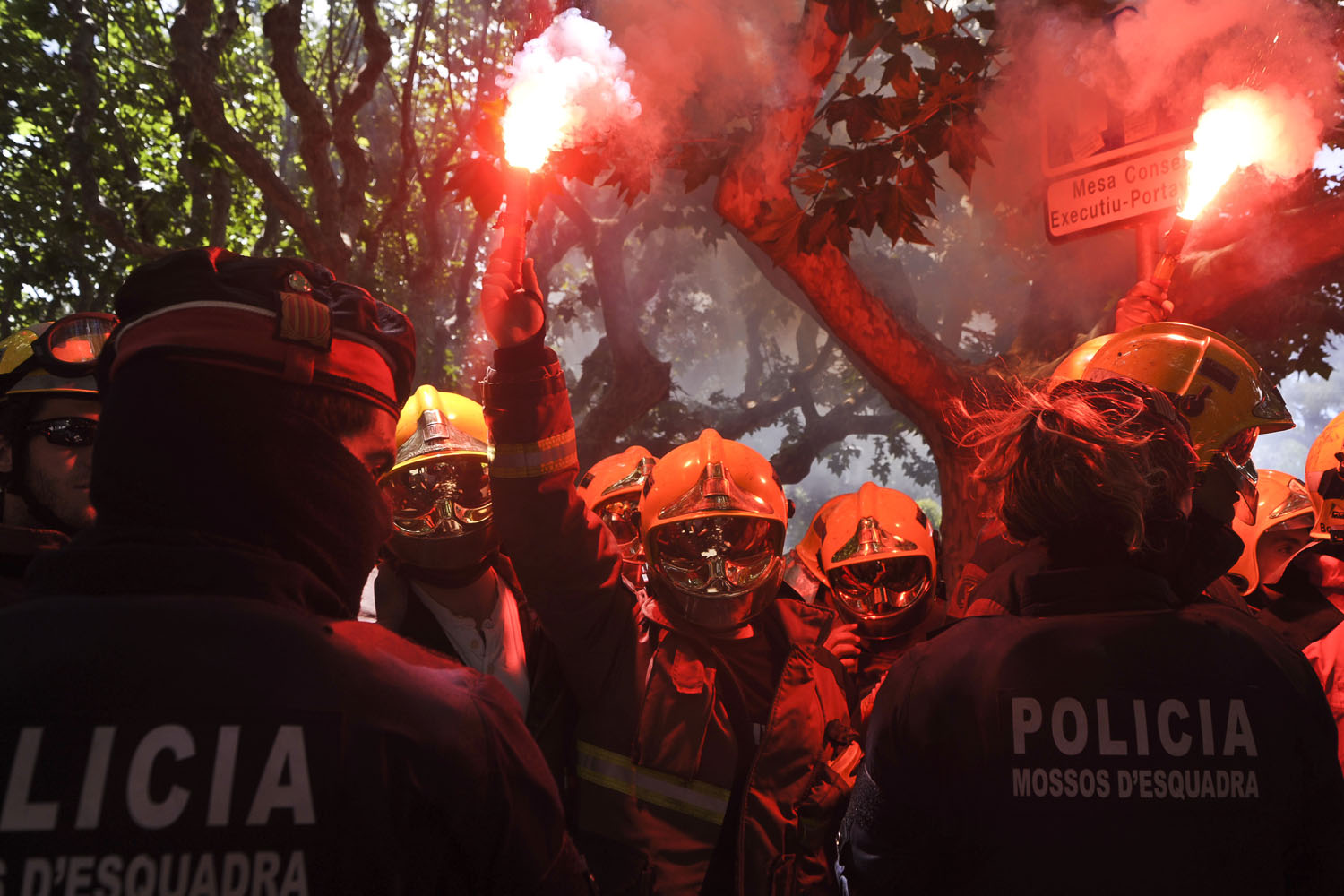 May 29, 2013. Firefighters with flares in front of the Mossos d'Esquadra in Spain. Approximately 400 firefighters from the Government protested in front of the autonomous Catalonia Parliament to criticize the lack of staff and resources in the face of this summer's forest campaign.