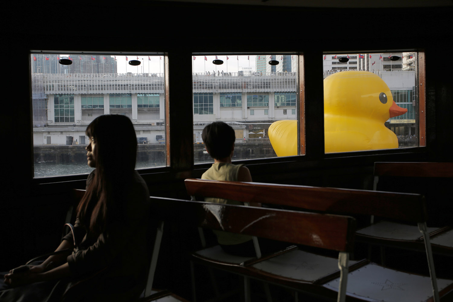 May 29, 2013. A giant rubber duck created by Dutch artist Florentijn Hofman is seen from the window of a star ferry along Hong Kong's Victoria Habour.