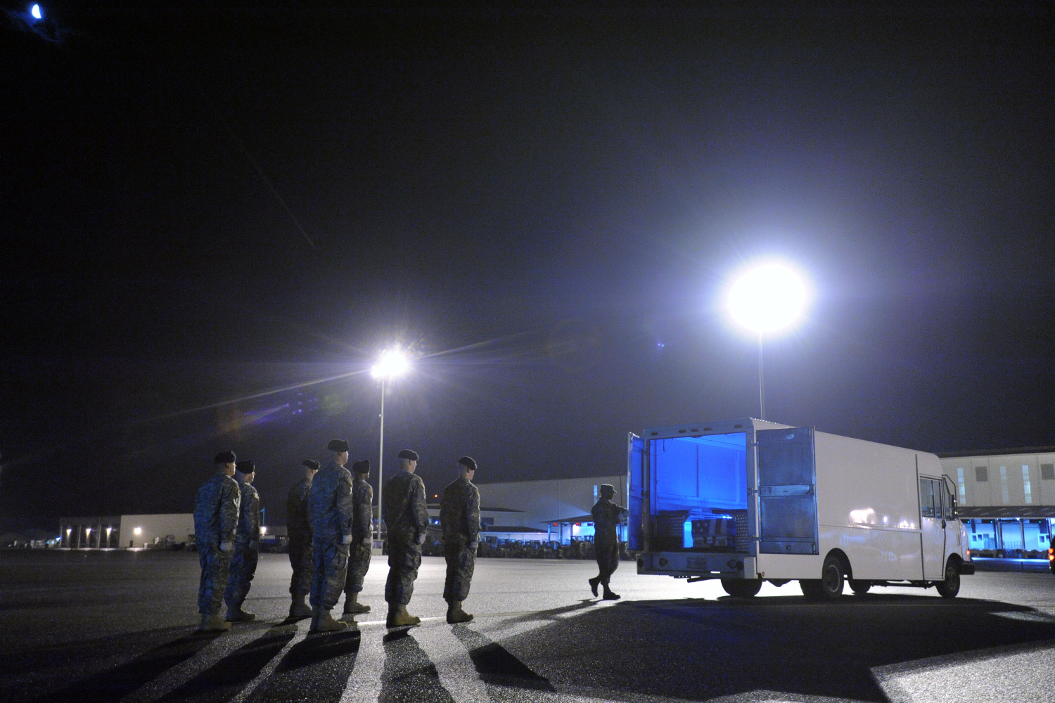 Senior Airman Kevin Gilliam, center, closes a transfer vehicle with transfer cases containing the remains of 1st Lt. Omar J. Vasquez and Pfc. Antonio G. Stiggins at Dover Air Force Base, Del., April 25, 2011.