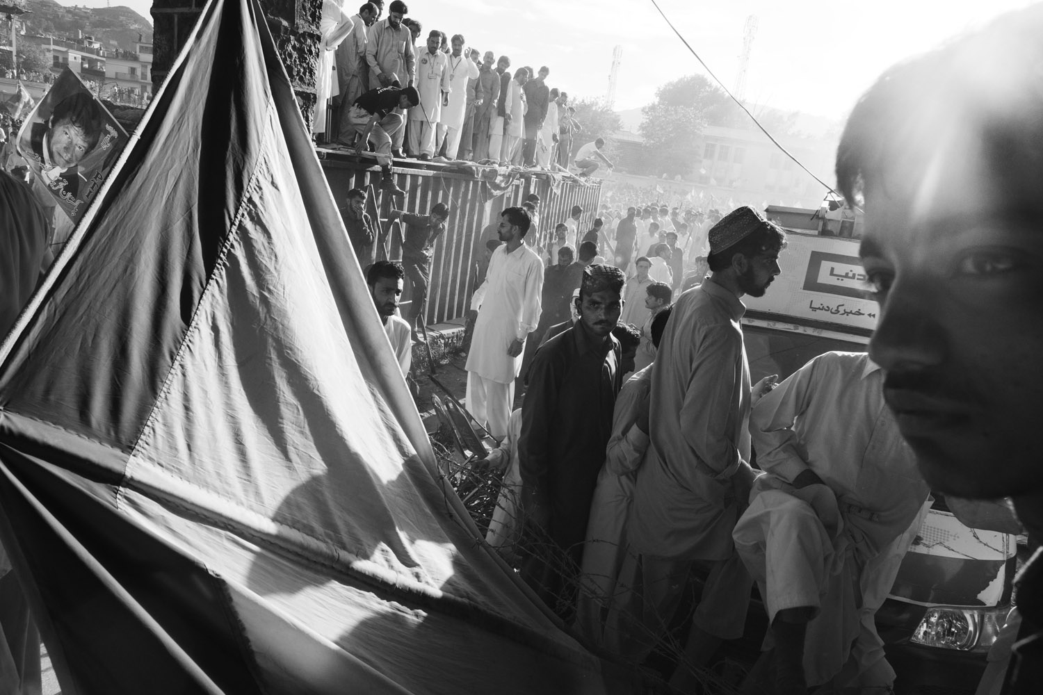 May 3, 2013. People cross security lines after PTI chairman Imran Khan left an election rally in Abbotabad.