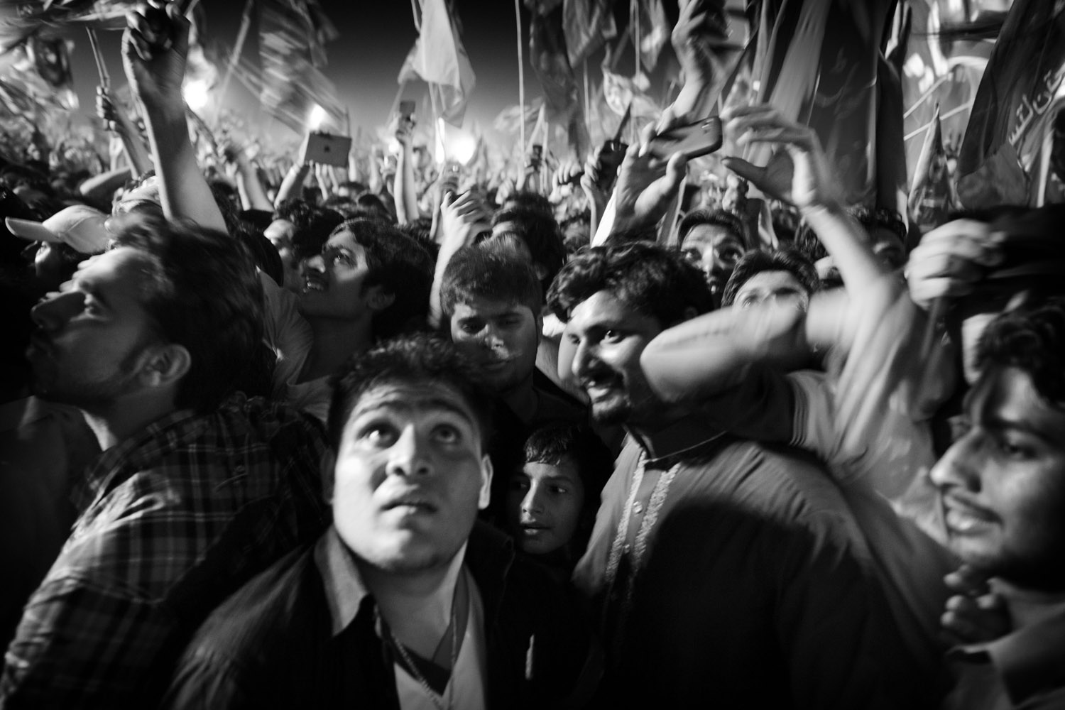 May 6, 2013. Supporters of Imran Khan listen to his speech in Jinna cricket stadium in Sialkot.