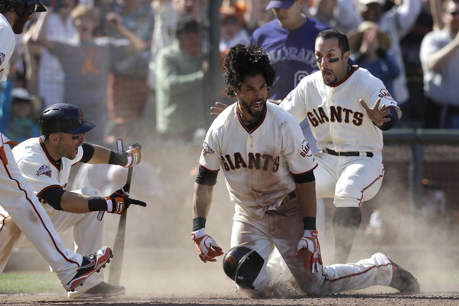 May 25, 2013. San Francisco Giants' Angel Pagan, center, celebrates with Marco Scutaro, left, and Andres Torres after hitting an inside the park two-run home run off of Colorado Rockies pitcher Rafael Betancourt during the 10th inning of a baseball game in San Francisco.