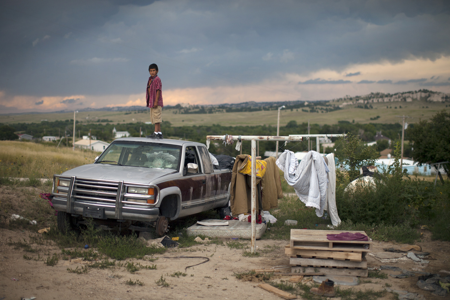 A young boy and truck, Manderson, SD.