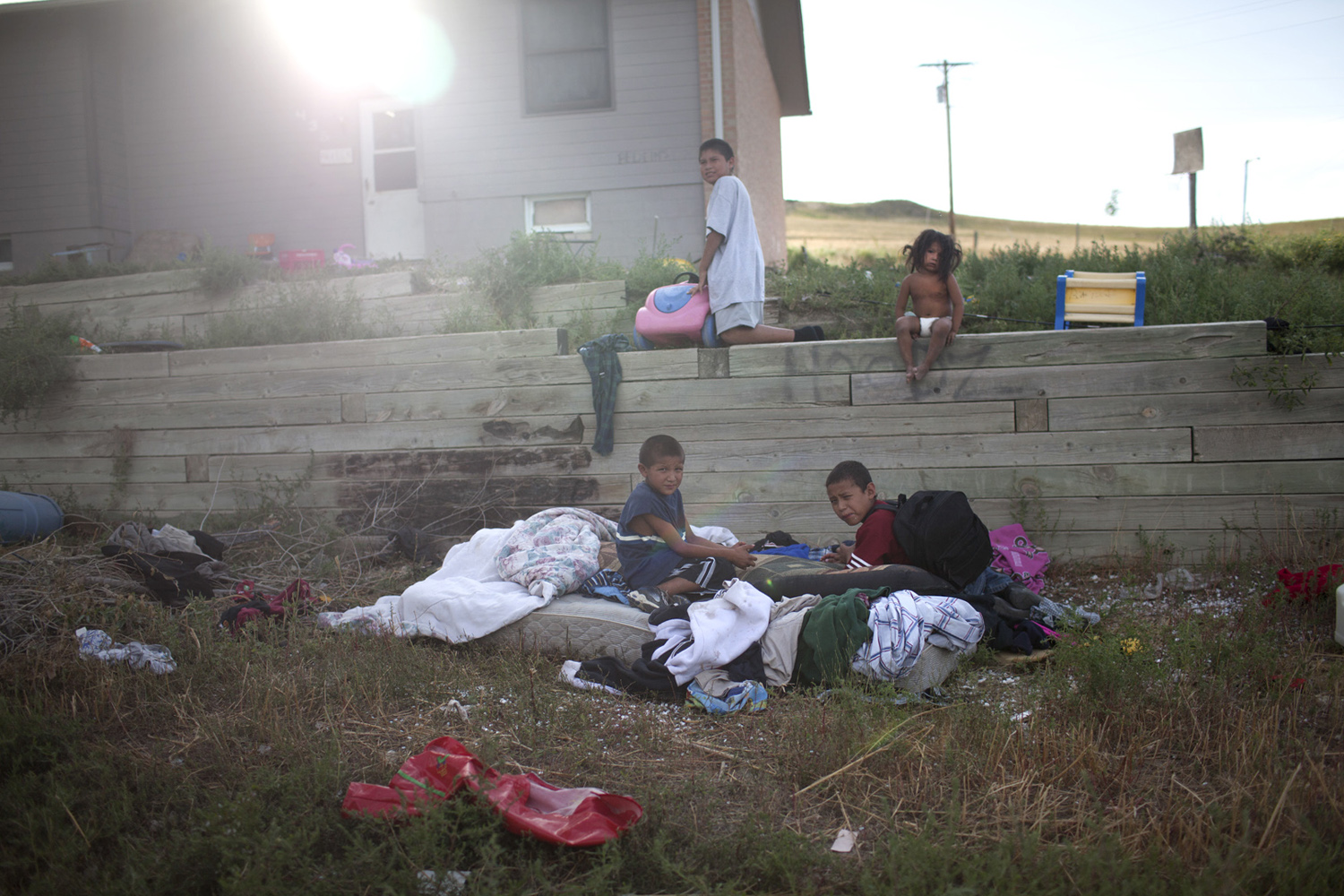 Children in the front yard of a home in Manderson, SD.