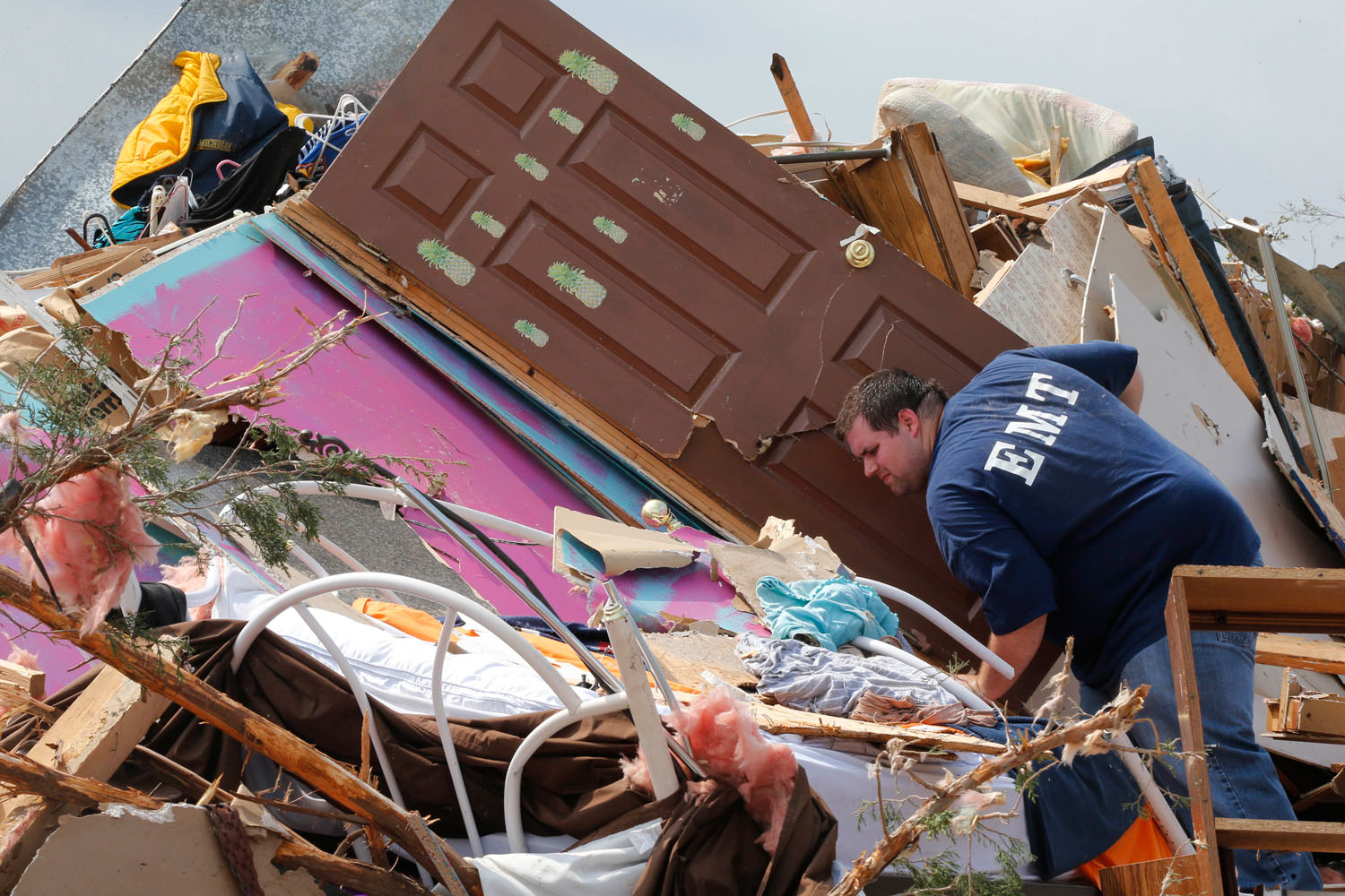 May 20, 2013. A man searches through the rubble of his mobile home, in the Steelman Estates Mobile Home Park, destroyed by a tornado, near Shawnee, Okla.