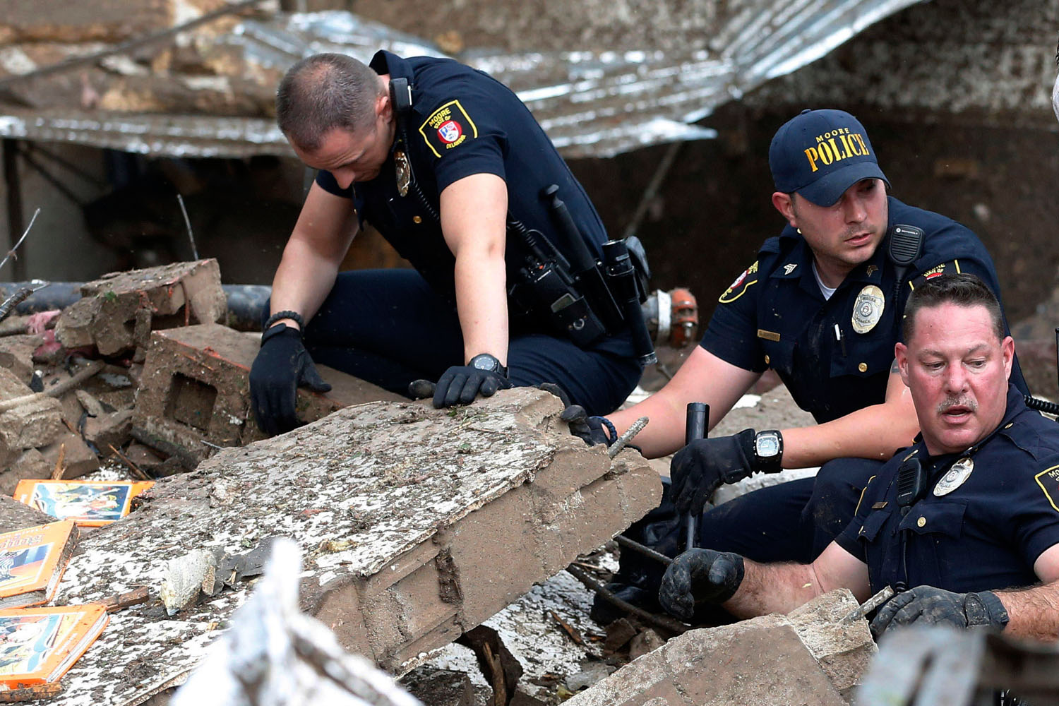 May 20, 2013. Moore police dig through the rubble of the Plaza Towers Elementary School.
