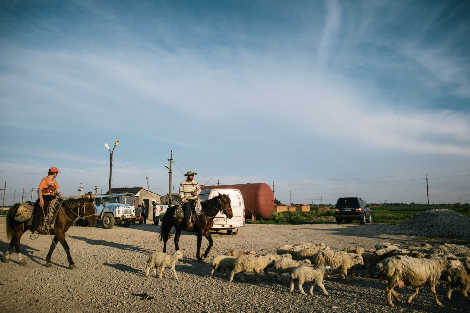 Two herders ride near the road from Kizlyar to Makhachkala on May 13, 2013.