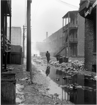 An alley between overcrowded tenements, with garbage thrown over the railings of the back porches. Most of the area's tenants were transient. Chicago, 1948. (Wayne Miller—Magnum)