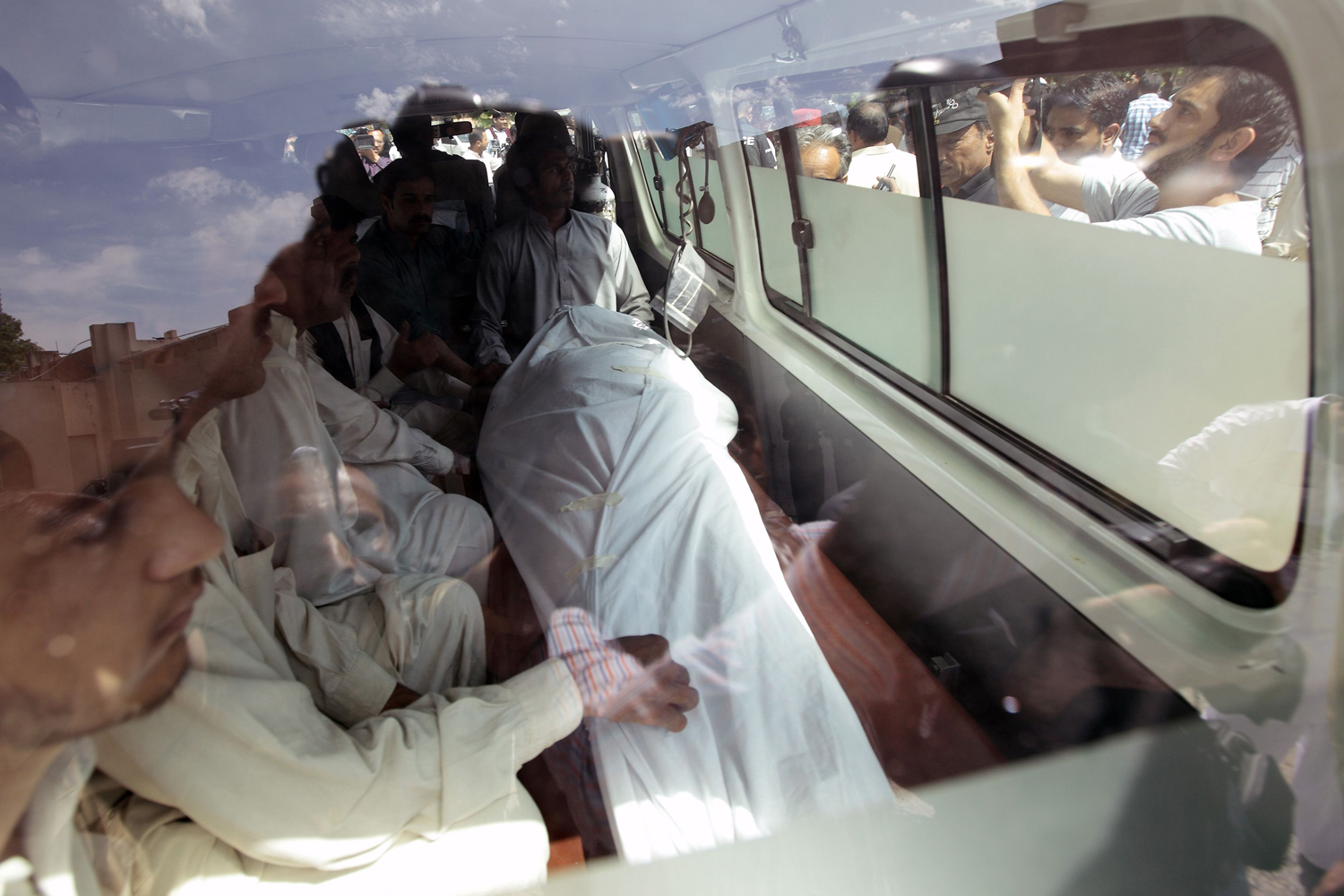 The body of Chaudhry Zulfikar, who was killed by unidentified gunmen, is seen through an ambulance window in Islamabad
